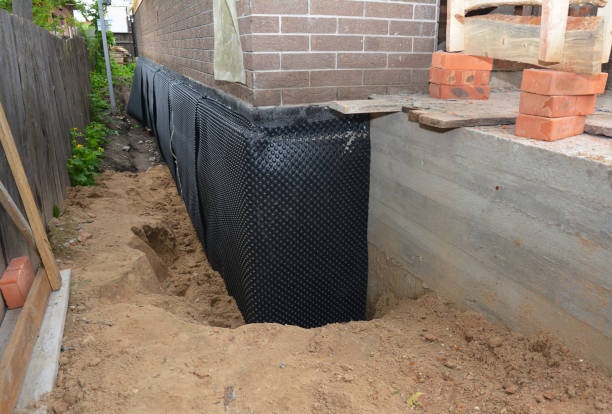 SJ Waterproofing Pros technician performing targeted Wet Basement Repair assessment in Ada, MN